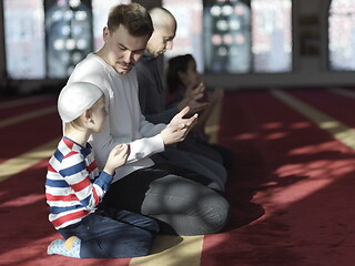 Image showing father and son in mosque praying