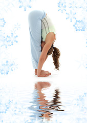 Image showing uttanasana standing forward bend on white sand