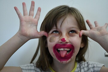 Image showing Little girl playing with mommy\'s make up