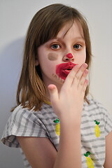 Image showing Little girl playing with mommy\'s make up