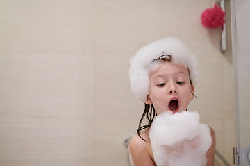 Image showing little girl in bath playing with soap foam