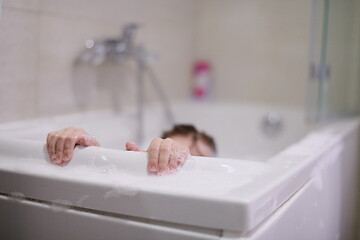 Image showing little girl in bath playing with soap foam