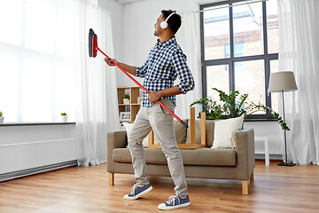 Image showing man with broom cleaning and having fun at home