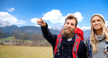 Image showing smiling couple with backpacks hiking in autumn