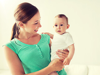 Image showing happy young mother with little baby at home