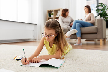 Image showing student girl writing to notebook at home