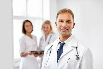 Image showing smiling doctor in white coat at hospital