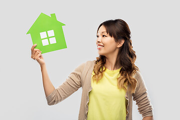 Image showing happy asian woman with green house