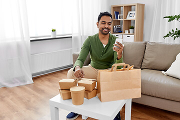 Image showing indian man checking takeaway food order at home