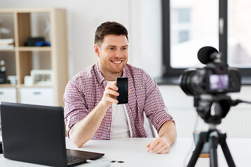 Image showing male blogger with smartphone videoblogging