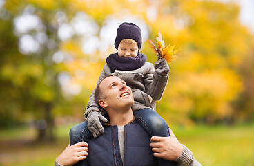 Image showing happy family having fun in autumn park