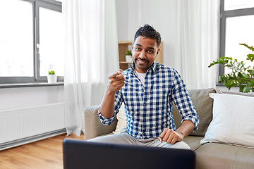 Image showing indian male blogger pointing to you at home