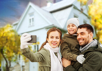 Image showing family taking selfie over house in autumn