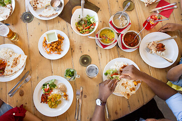 Image showing african american friends eating at restaurant