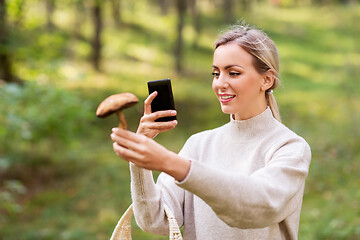 Image showing woman using smartphone to identify mushroom