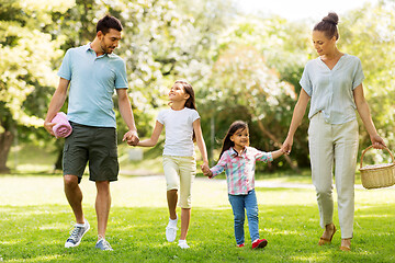 Image showing family with picnic basket walking in summer park