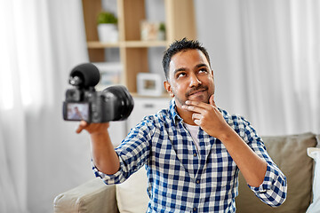 Image showing male video blogger with camera blogging at home