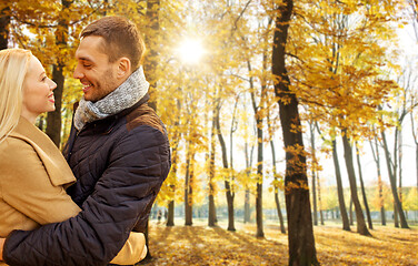 Image showing smiling couple hugging in autumn park