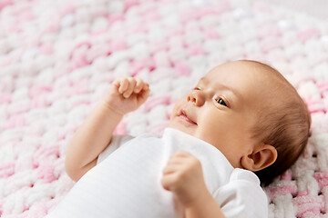 Image showing sweet baby girl lying on knitted plush blanket