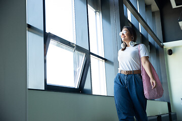 Image showing Young woman waiting for departure in airport, traveler with small baggage, influencer\'s lifestyle