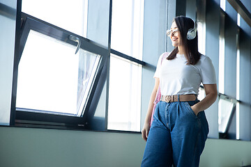 Image showing Young woman waiting for departure in airport, traveler with small baggage, influencer\'s lifestyle