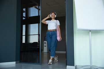 Image showing Young woman waiting for departure in airport, traveler with small baggage, influencer\'s lifestyle