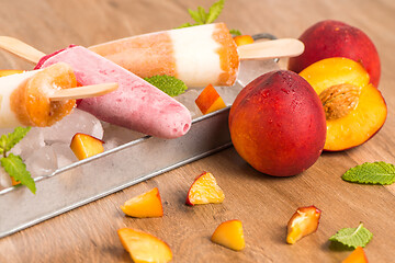 Image showing Homemade raspberries and peach popsicles