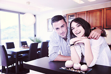 Image showing happy young couple have fun in modern kitchen