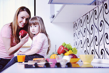 Image showing happy daughter and mom in kitchen