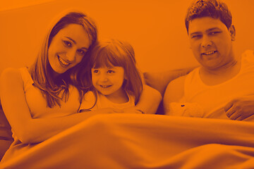 Image showing happy family relaxing in bed