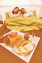 Image showing happy young family eat breakfast in bed