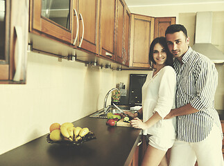 Image showing happy young couple have fun in modern kitchen