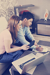 Image showing young couple working on laptop at home