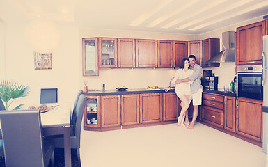 Image showing happy young couple have fun in modern kitchen