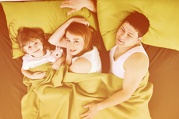 Image showing happy family relaxing in bed