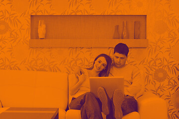 Image showing young couple working on laptop at home