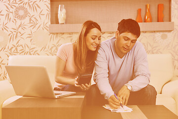 Image showing young couple working on laptop at home