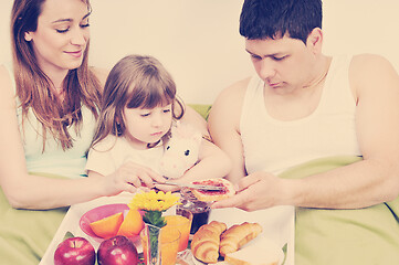 Image showing happy young family eat breakfast in bed