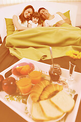 Image showing happy young family eat breakfast in bed