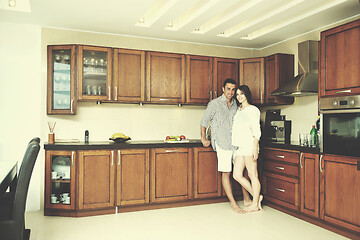 Image showing happy young couple have fun in modern kitchen