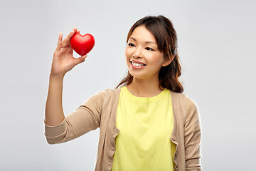 Image showing happy asian woman holding red heart