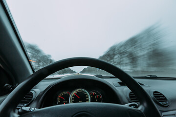 Image showing Riding behind the wheel of a car in winter