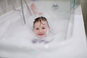 Image showing little girl in bath playing with soap foam