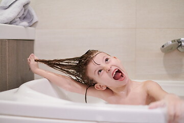 Image showing little girl in bath playing with soap foam