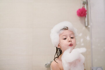 Image showing little girl in bath playing with soap foam