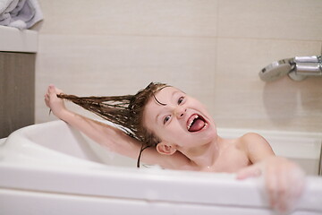 Image showing little girl in bath playing with soap foam