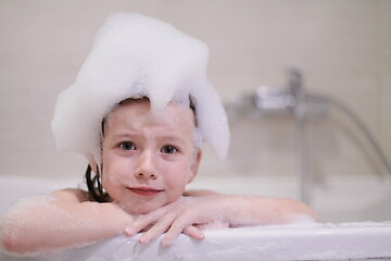 Image showing little girl in bath playing with soap foam