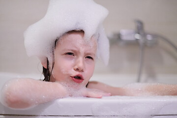 Image showing little girl in bath playing with soap foam