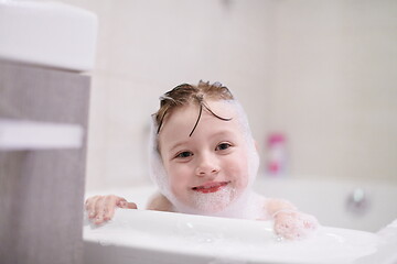 Image showing little girl in bath playing with soap foam