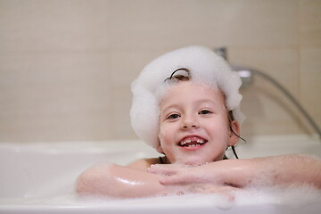 Image showing little girl in bath playing with soap foam